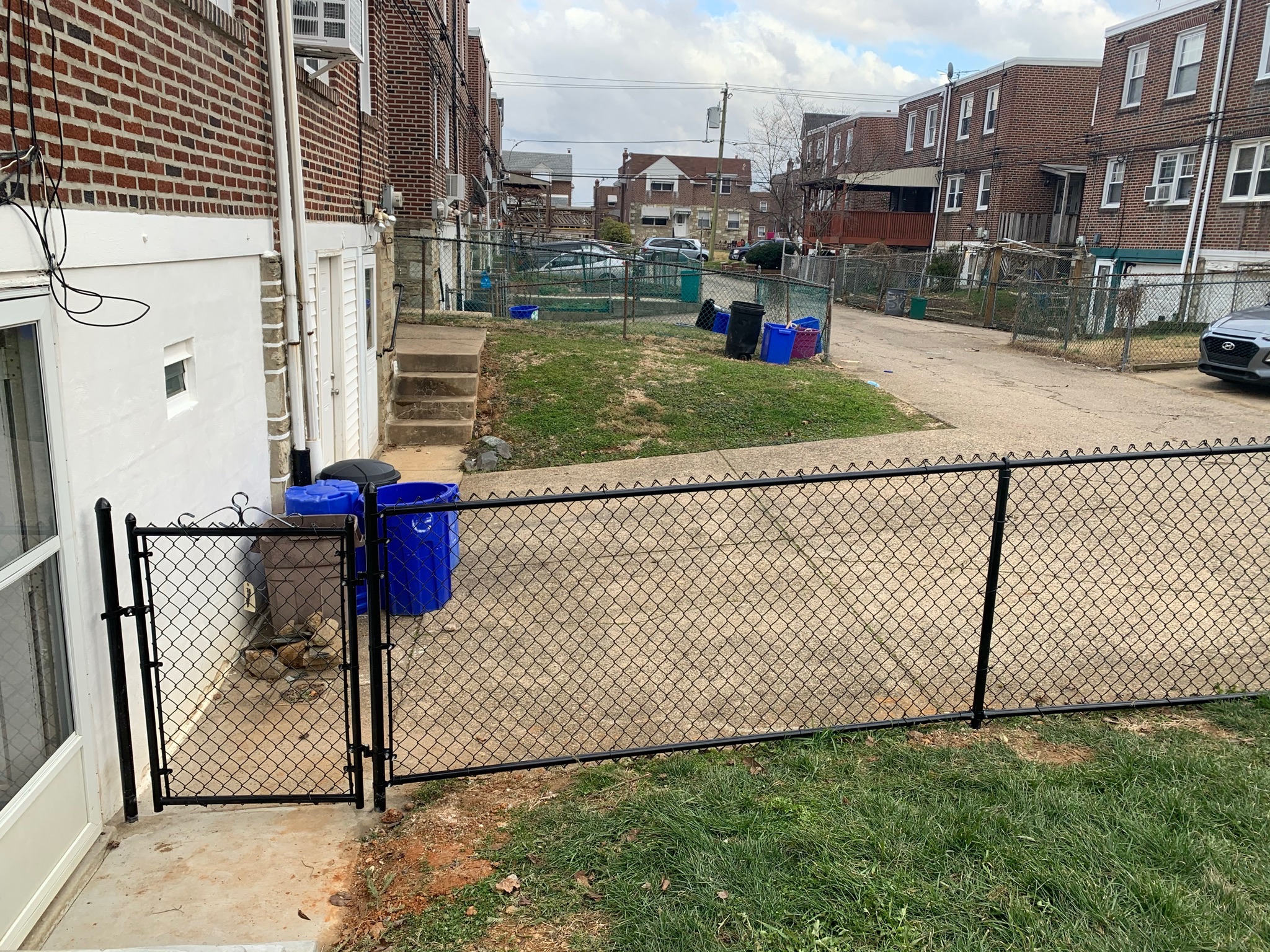Black corner gate and chain link fence