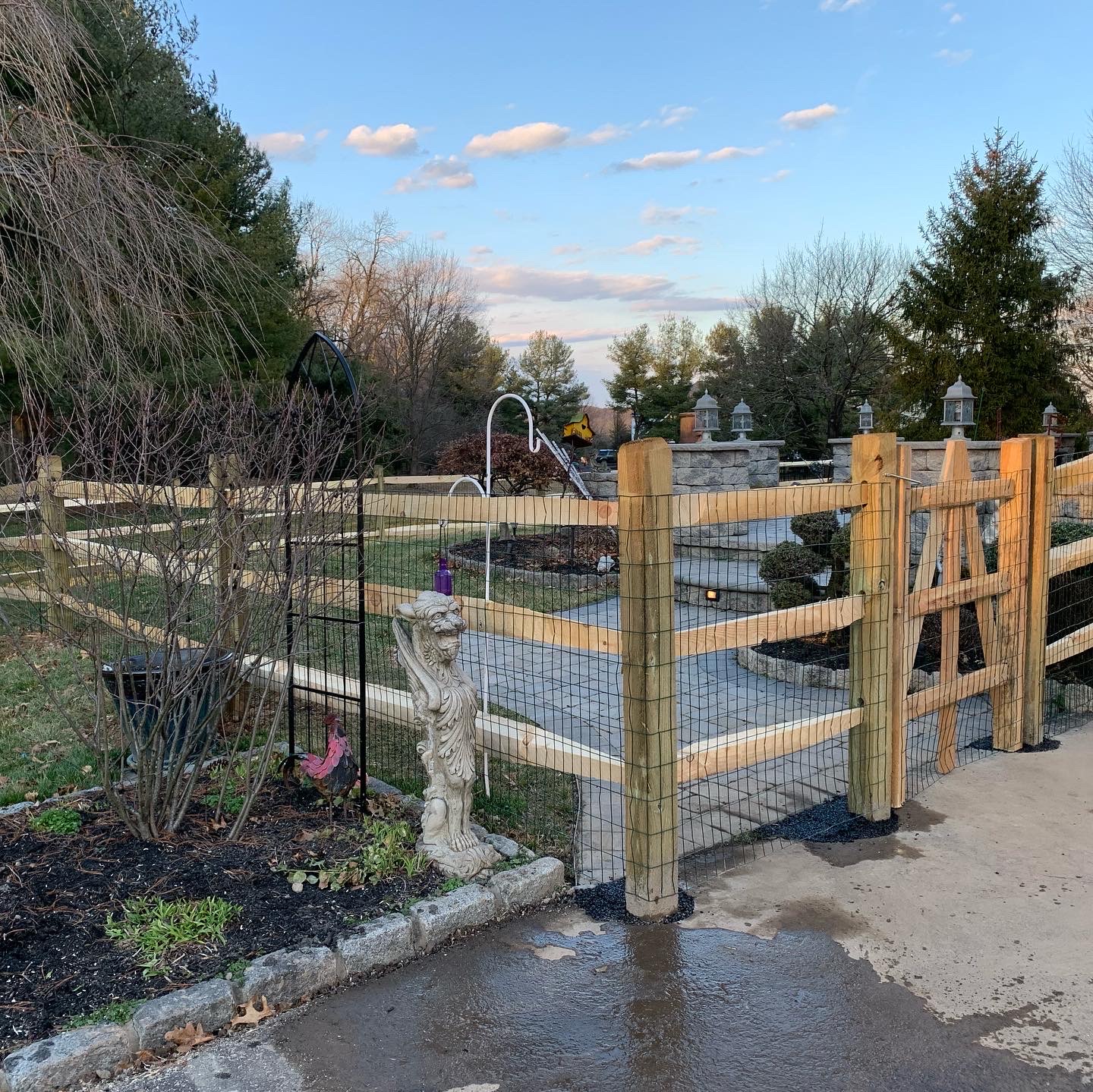 Scalloped wood fence with stone landscaping
